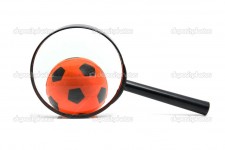 black magnifying glass with soccer ball
